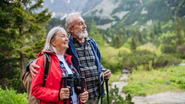 istock Active senior couple hiking together in autumn mountains. 1624712340