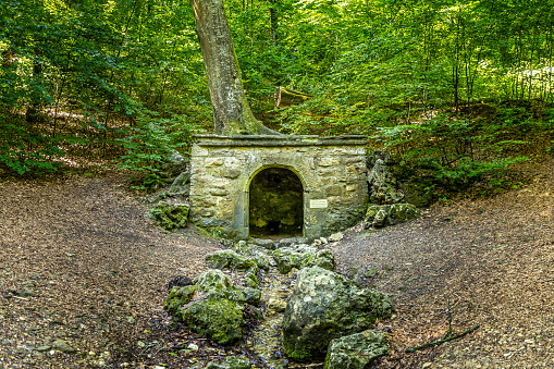 Old roman fountain in a forest of Weissenburg, Franconia