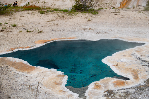 The colorful minerals and waters of the geothemal hot pools at Old Faithful in Yellowstone National Park in summer.