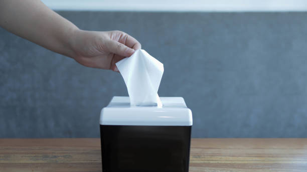 istock Someone pickup a tissue from a tissue box. A hand pick the tissue or holding a tissue. 1624728677
