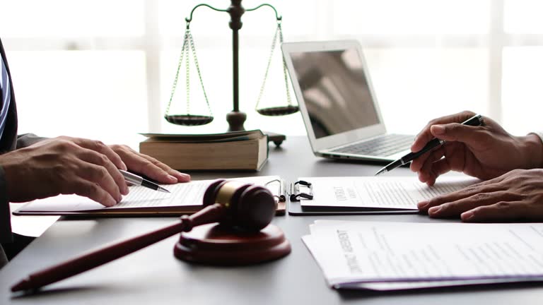 Businessmen discussing with lawyers or legal advisors working together on documents, contracts, legal agreements for signing.