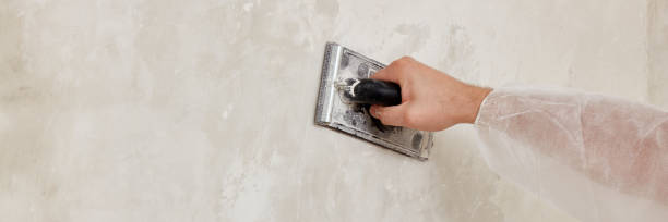 istock Hand of a man sanding a wall after plastering 1624791346