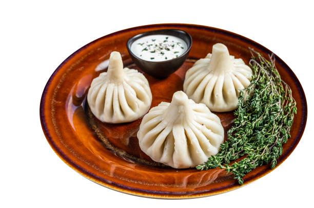 istock Khinkali Dumplings with beef and lamb meat on rustic plate with herbs.  High quality Isolate, white background. 1624840662