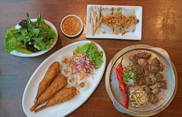 istock Delectable Popular Vietnamese Dishes Served on Wooden Table 1624862447