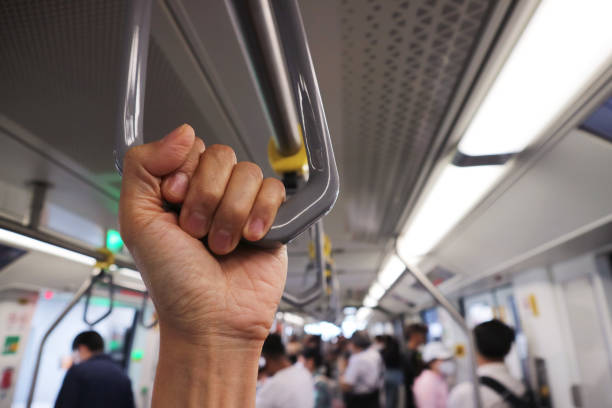 istock Closeup of a Hand Holding a Hanging Strap on the Commuter 1624863536