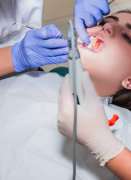 istock Dentist and his assistant carrying out a thorough examination (real treatment) 1624874905