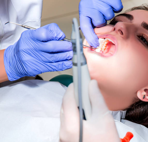 istock Dentist and his assistant carrying out a thorough examination (real treatment) 1624876580