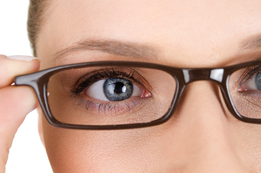 close up of woman wearing eyeglasses, isolated on white background
