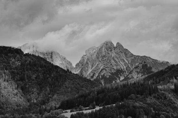 Alps mountains in stormy clouds, in black and white