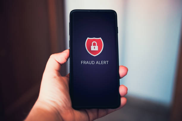 istock Woman use smartphone with fraud alert on screen. 1624915160