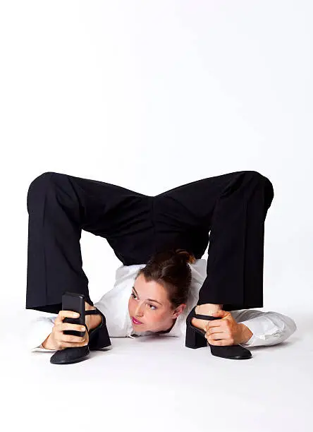 young business woman contortionist with cell phone in hand - on white background
