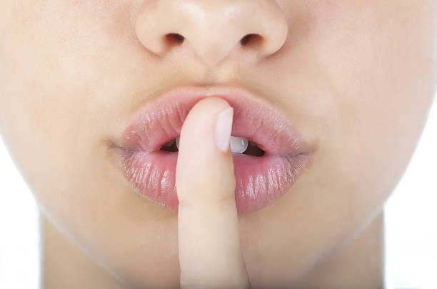 istock Woman lips and finger 162493463