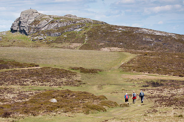 Haytor rocks and three walkers on Dartmoor, Devon stock photo