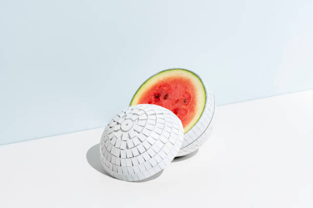 istock Creative concept of summer fruits. Mirrored white disco ball with watermelon inside on white background. 1624955814
