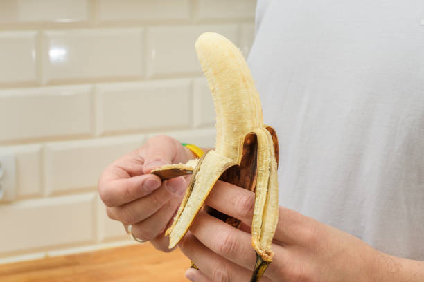 istock Peeled banana held in hands like a monkey 1624960764