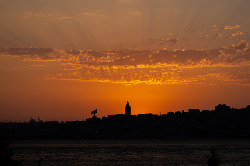 Clouds and sun shines through rays of light in the illuminated picturesque sky.