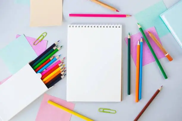 Photo of Back to school, colorful sticky notes and multicolored pencils, drawing supplies