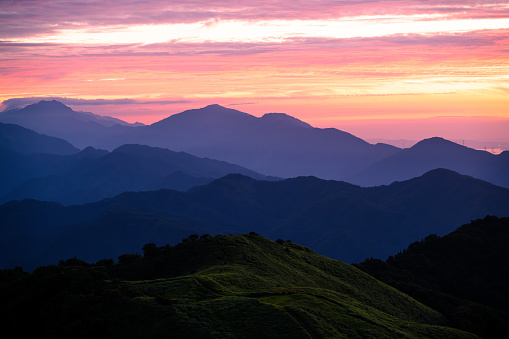 beautiful quiet sunset among the mountain valley with blue mist