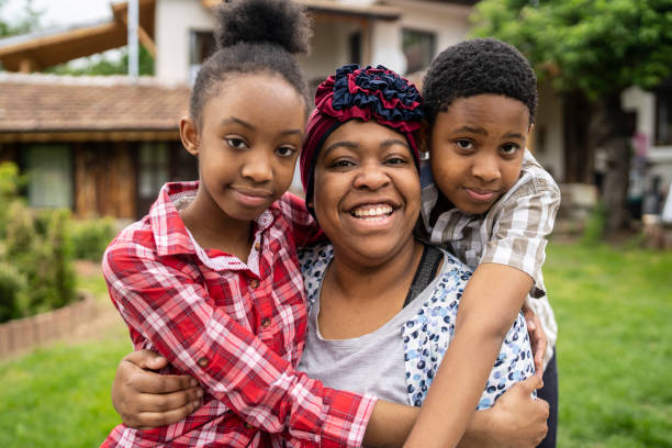 istock A single mother with two children looking at camera and smiling 1625003323