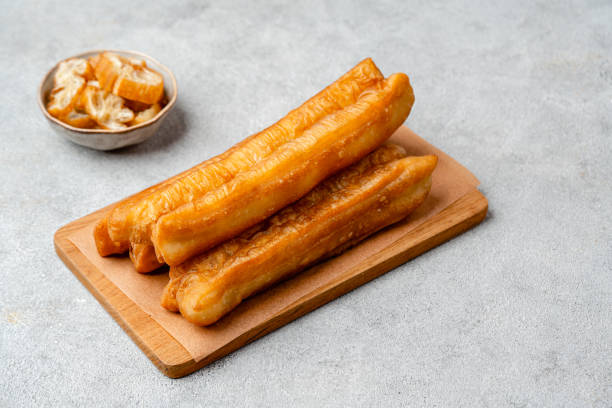 Youtiao or Yu Char Kway Youtiao or Yu Char Kway is a long golden-brown deep-fried strip of wheat flour dough of Chinese origin gorengan stock pictures, royalty-free photos & images