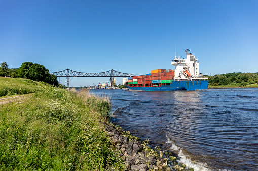 container ship in the Kiel Canal with the famous Rendsburg High Bridge in the background