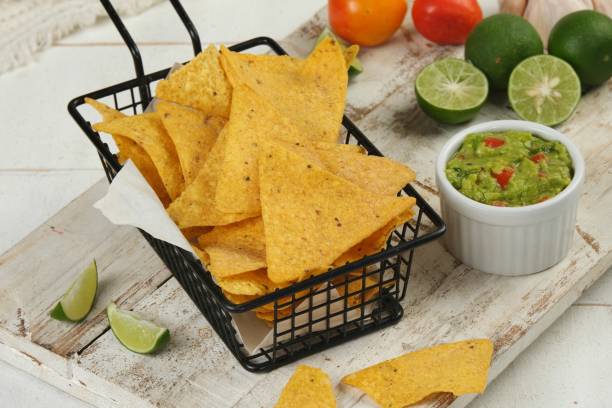 istock Mexican Nachos chips and dip sauces. Tortilla corn nachos chips with guacamole. 1625097667