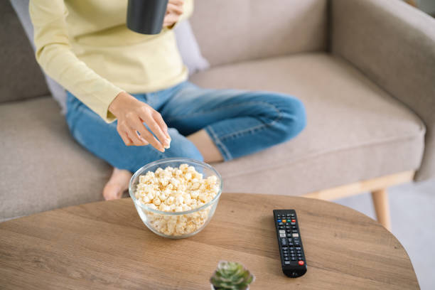 istock Asian woman Watching smart TV and using remote controller Hand holding television audio remote control at home with the remote control television 1625118809