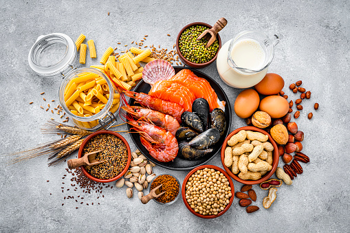 Most common allergens food shot from above. The composition includes fish, crustaceans mussels, peanut, eggs, milk soy products, bee pollen, nuts, wheat and derivates and sesame. High resolution 42Mp studio digital capture taken with SONY A7rII and Zeiss Batis 40mm F2.0 CF lens