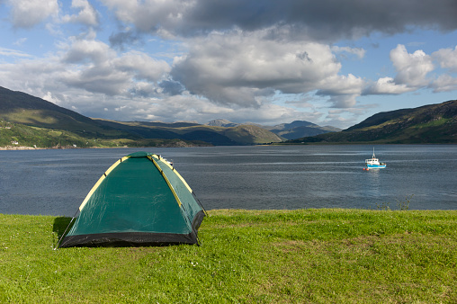 A tent on the lawn at the edge of Loch Broom, the main viewing point of Ullapool, Scotland.