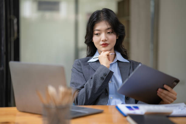istock Attractive business Asian woman using a digital tablet while sitting at a workplace desk in an office. 1625142639