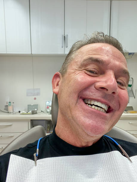 istock Attractive man tilts his head to the side to show his new teeth 1625144233