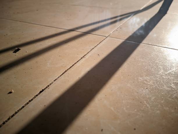 istock The beam of sunlight onto an object forms a black shadow with three thick lines on the surface of the tiled floor 1625192238