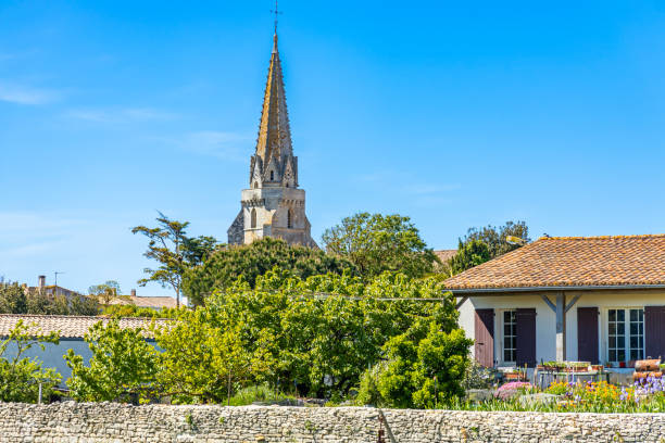 Bell tower of Notre-Dame-de-l'Assomption church in Sainte-Marie-de-Ré Bell tower of Notre-Dame-de-l'Assomption church in Sainte-Marie-de-Ré, France sainte marie stock pictures, royalty-free photos & images