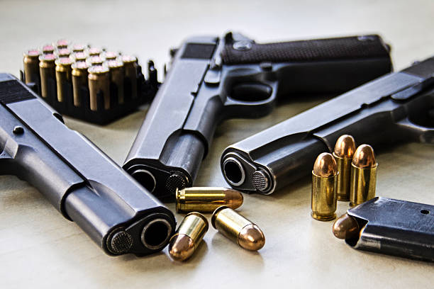 Three pistols Three pistols laying on table with bullets ammunition photos stock pictures, royalty-free photos & images