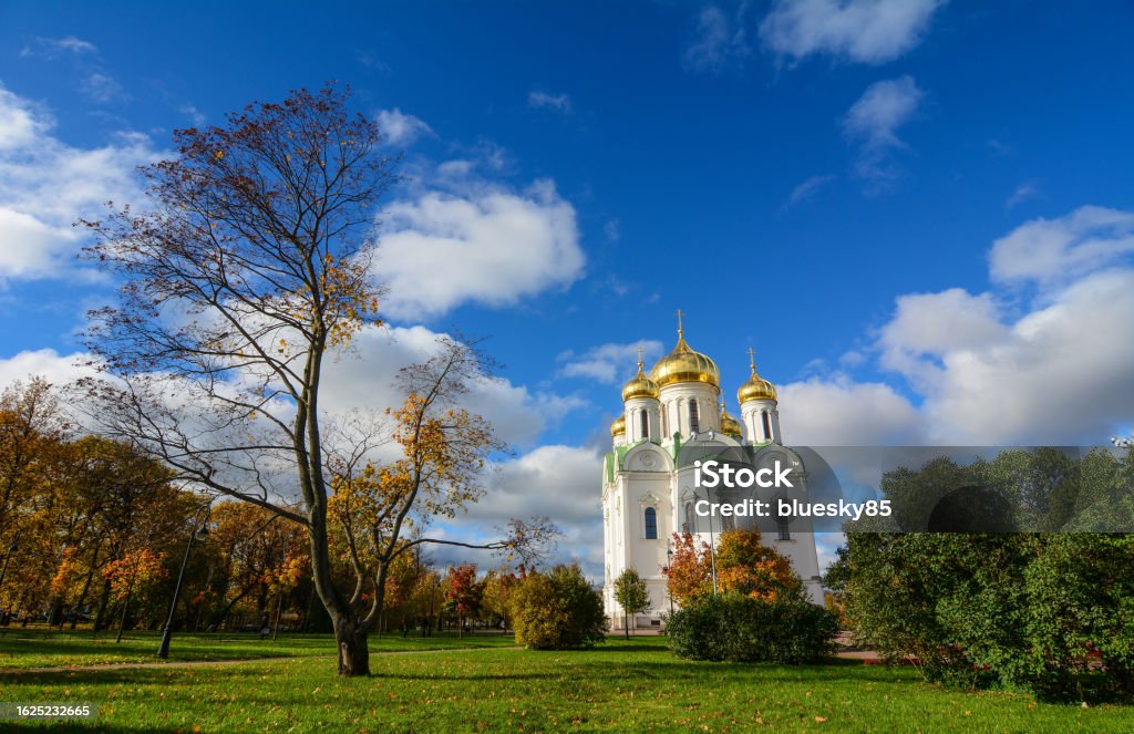 Old church in Saint Petersburg, Russia Cathedral of St. Catherine with autumn garden in Saint Petersburg, Russia. St. Catherine is the oldest Catholic church in the Russian Federation. Ancient Stock Photo