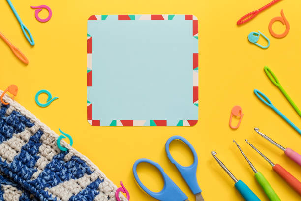 istock Bright crochet accesories,crochet project and blue empty card on a yellow background. Top view. Copy space. 1625239722