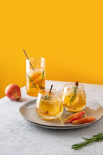 istock Fresh cocktail with pear, ice and herbs on the  table. Refreshing drink on a hot summer day. Ice tea. Pear sangria or punch in a glass 1625242425