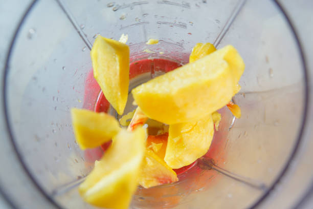 Yellow peach in the food processor view from above