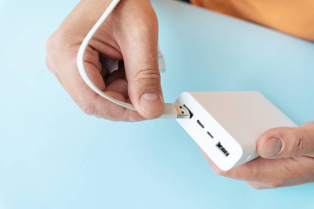 istock Charging a power bank, a man connects the cable to the cell. 1625258720