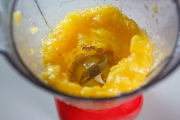 istock Yellow peach in the food processor view from above 1625260485