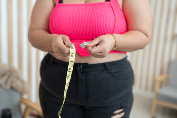 istock Unknown plus size woman use measure tape at home 1625260532