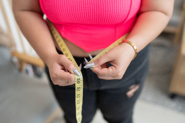 istock Unknown plus size woman use measure tape at home 1625260534