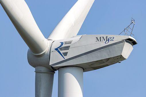 Oster-Ohrstedt, Germany - June 18, 2021: Repower MM 82 wind turbine against blue sky