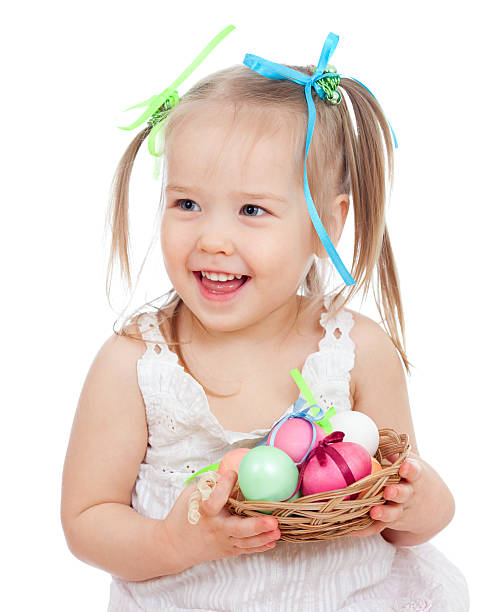 istock cute smiling baby girl holding Easter eggs in basket isolated 162526921