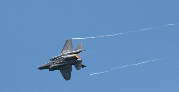 Tal Aviv, Israel – April 27, 2023: A fighter jet is flying in formation through a crisp, blue sky in Tel Aviv, Isreal
