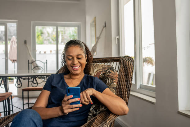 istock Black woman using smartphone at home 1625301655
