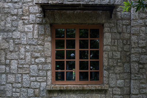 Background of old window in wall without frame with view of forest soft focus