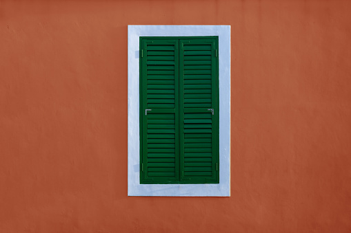 Retro style green louvers on red walls