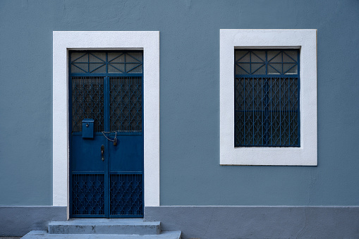 Retro style blue walls with iron windows and doors