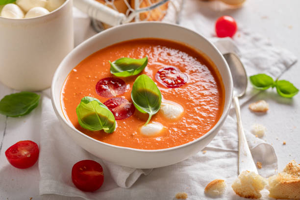 Vegan tomato soup with mozzarella cheese and crostini.